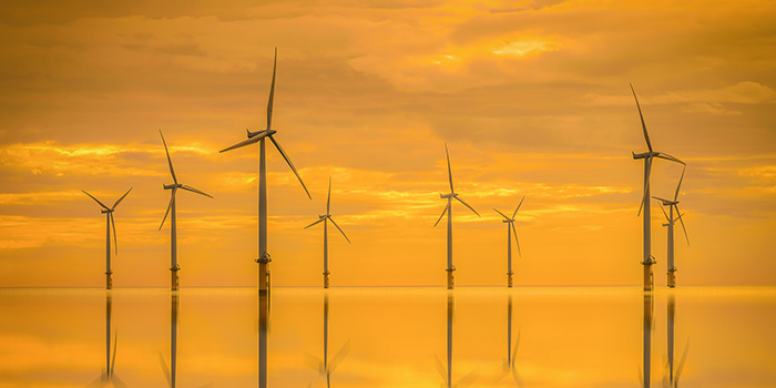 Offshore wind turbine farm in the sunset