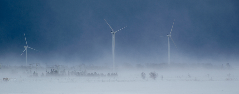 wind turbines during the winter season with snow all around